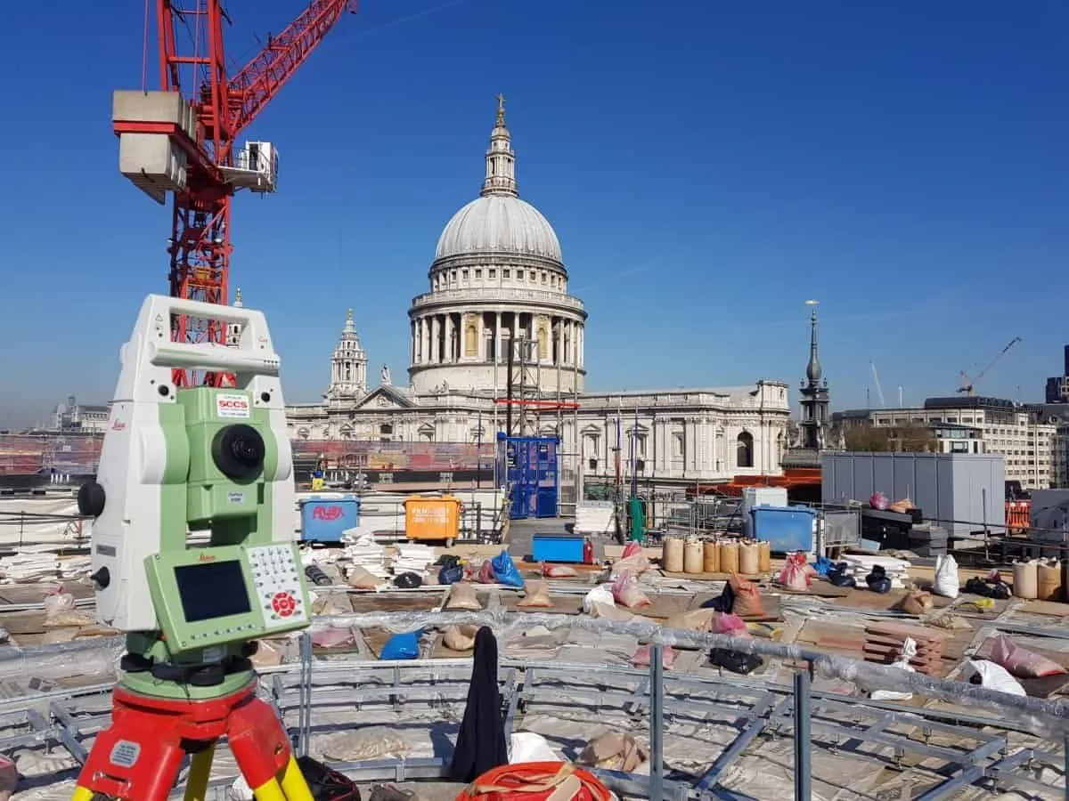 Robotic total station setting out on a rooftop construction site opposite St Paul's Cathedral